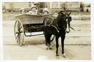 Reynolds children Mary, Dick, and Nancy (left to right) with driver in trap with pony on trolle ...