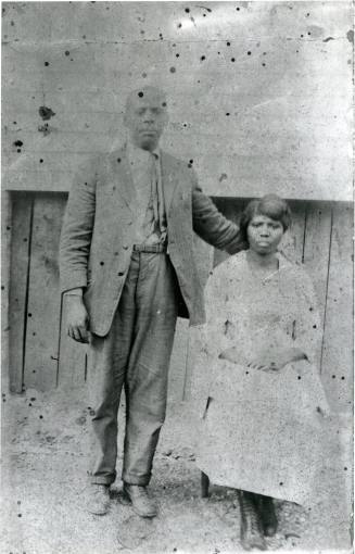 Ellis and Flora Pledger near a building in Five Row, circa 1915