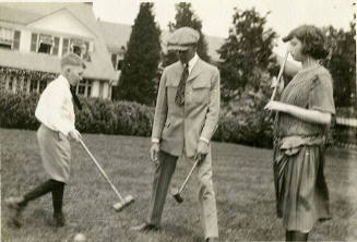 Smith Reynolds, Cleveland Williams, and Nancy Reynolds playing croquet on the front lawn of Rey ...