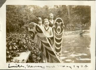 Smith, Nancy, and Mary Reynolds standing beside pool with float boards, 1924