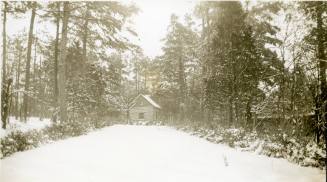 Log cabin in snow, undated