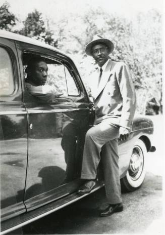Paul Hamlin sitting in automobile with Hugh Davis, circa 1940